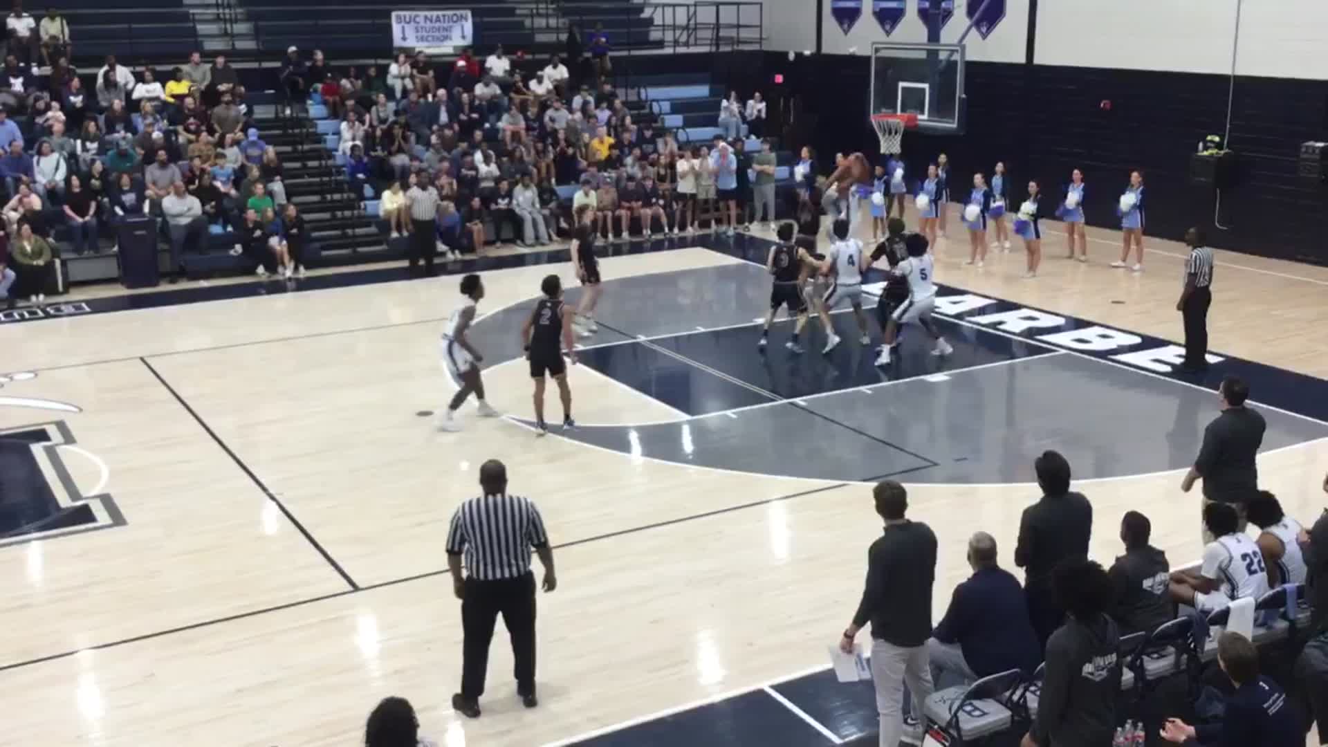 Basketball game in progress, players competing near the hoop
